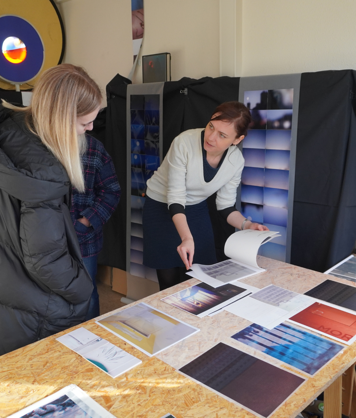 Dana reviewing prints with a visitor at her studio